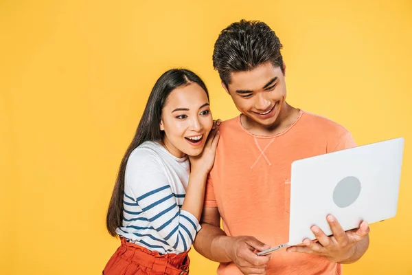 Young Asian Man Using Laptop Excited Girlfriend Isolated Yellow — Stock Photo, Image