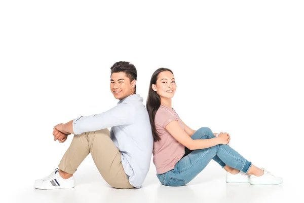 Young Asian Couple Sitting Back Back Looking Camera White Background — Stock Photo, Image