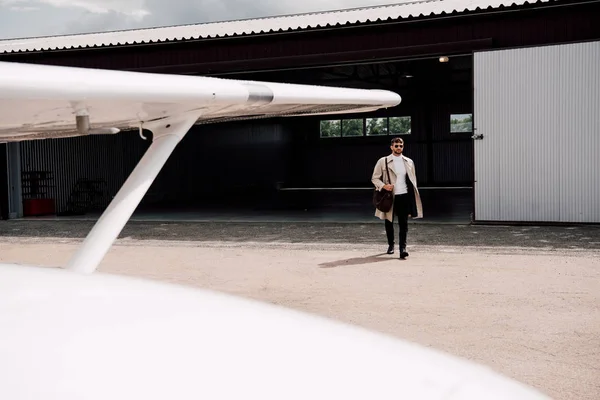 Full Length View Man Coat Bag Plane Foreground — Stock Photo, Image