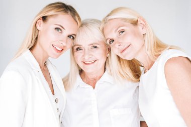 three generation blonde beautiful women isolated on grey clipart