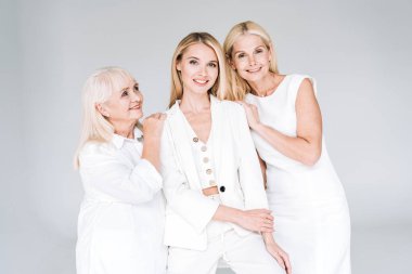 three generation blonde women smiling isolated on grey clipart