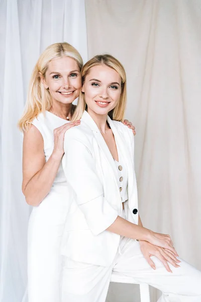 Smiling Elegant Blonde Mature Mother Gently Hugging Young Daughter — Stock Photo, Image