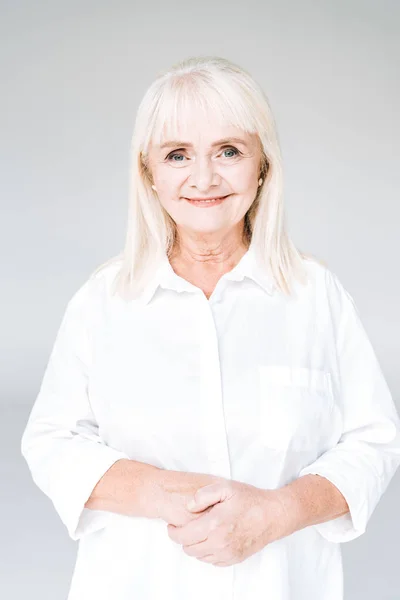 Happy Blonde Senior Woman White Clothes Looking Camera Isolated Grey — Stock Photo, Image