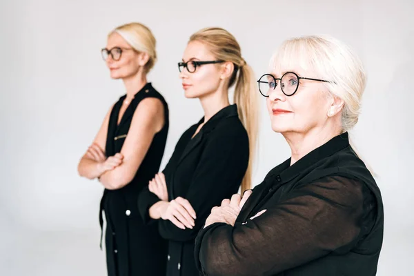 Fashionable Three Generation Blonde Businesswomen Total Black Outfits Glasses Crossed — Stock Photo, Image