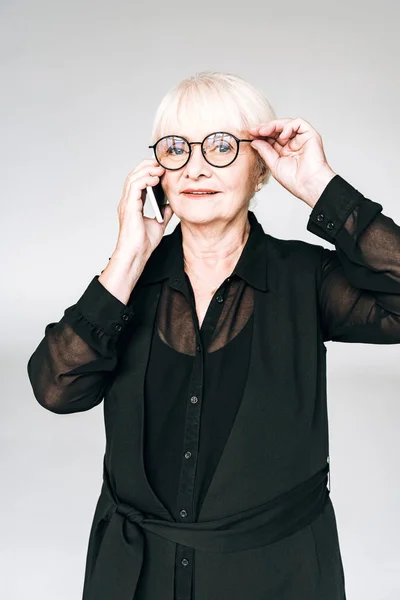 Senior Businesswoman Black Outfit Glasses Talking Smartphone Isolated Grey — Stock Photo, Image