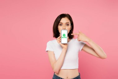 Kiev, Ukrayna - 3 Temmuz 2019: pembe izole spotify logosu ile akıllı telefon parmak ile işaret şok kız