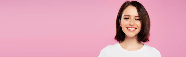 panoramic shot of beautiful smiling girl isolated on pink