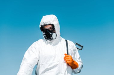 exterminator in white uniform and latex glove holding spray  clipart