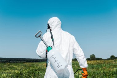 exterminator in white uniform with toxic spray outside  clipart