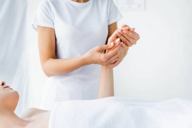 kadına el masajı yapan masör kırpılmış görünümü 