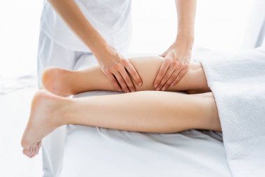 spa kadına ayak masajı yapan masör kırpılmış görünümü 