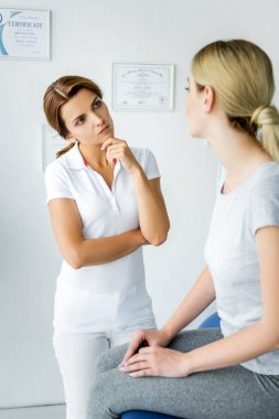 gri t-shirt hasta bakarak pensive chiropractor seçici odak 