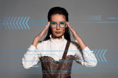 Steampunk kadını gözlüğe dokunuyor. Gri üzerinde izole edilmiş ve veri resimli.