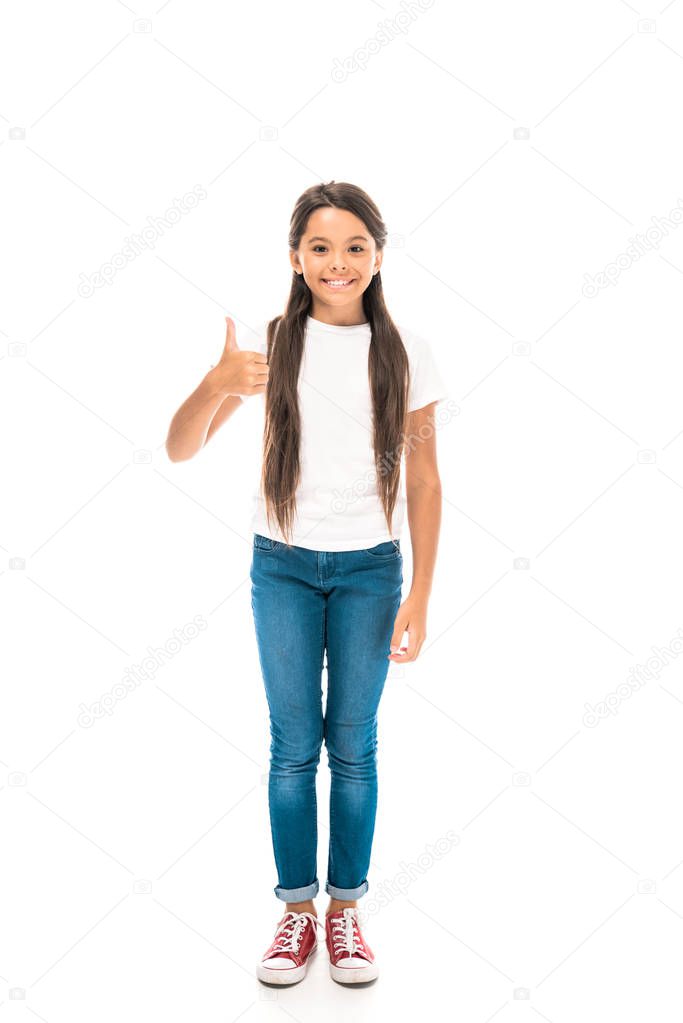 happy kid in blue jeans showing thumb up isolated on white 