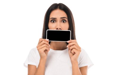 surprised woman covering mouth with smartphone isolated on white  clipart