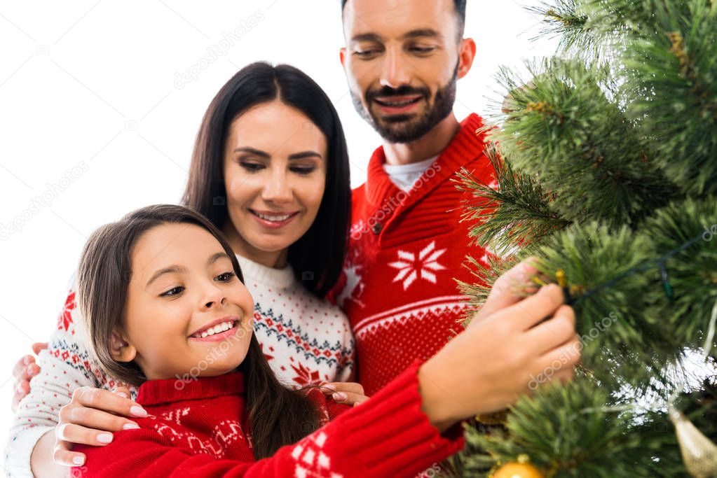 cheerful kid decorating christmas tree near parents isolated on white 