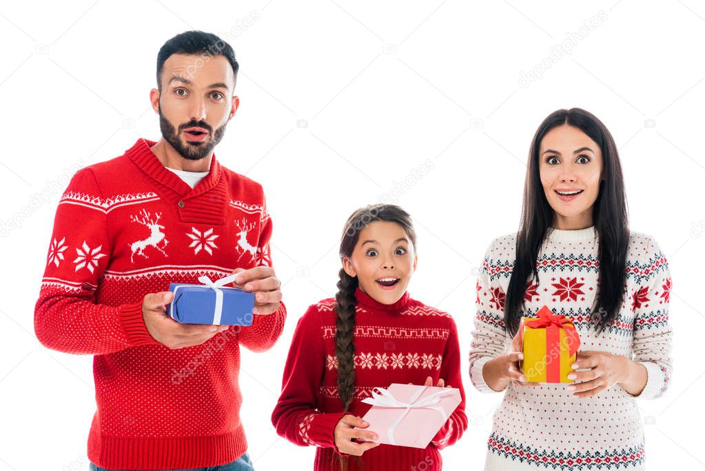 excited family in sweaters holding presents isolated on white 