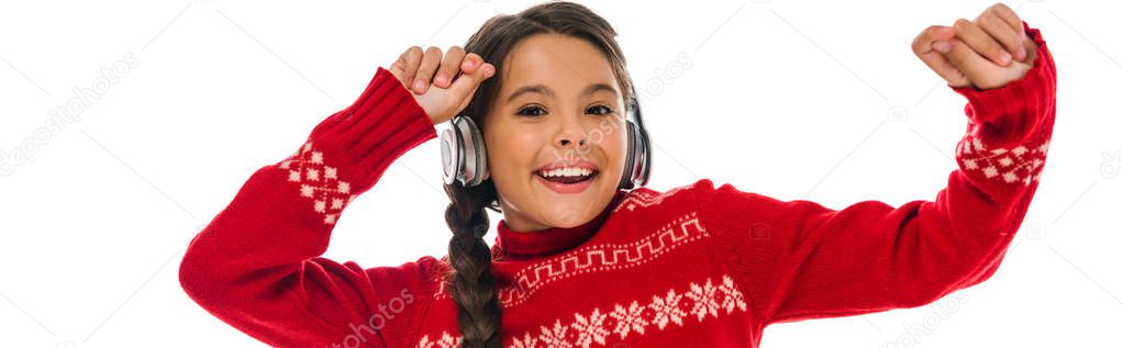 panoramic shot of happy kid in headphones gesturing isolated on white 