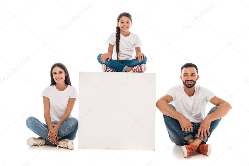 happy kid sitting on cube near cheerful parents isolated on white 