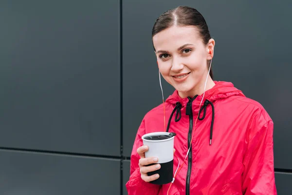 Smiling Sportswoman Holding Cup Listening Music Earphones Street — Stock Photo, Image