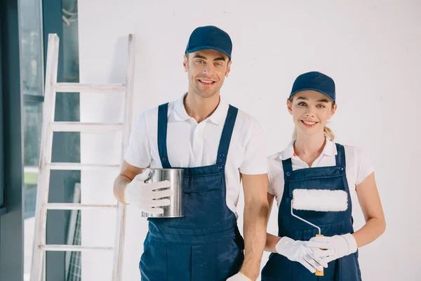 Attractive Painter Uniform Holding Paint Roller While Standing Colleague Holding — Stock Photo, Image