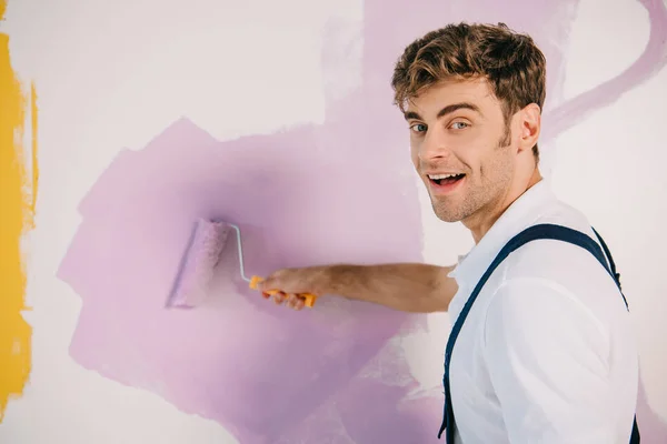 Handsome Young Painter Painting Wall Pink Color Paint Roller Smiling — Stock Photo, Image