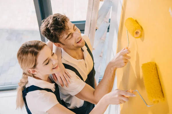 High Angle View Young Painters Overalls Painting Wall Yellow — Stock Photo, Image