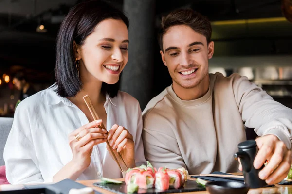 Cheerful Man Holding Black Bottle Woman Sushi — Stock Photo, Image