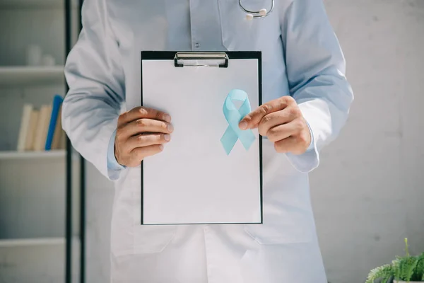 Oříznutý Pohled Lékaře Držícího Schránku Čistým Papírem Modrou Informační Stuhou — Stock fotografie