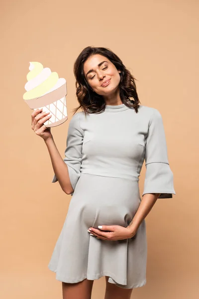 Pregnant Woman Grey Dress Holding Paper Cake Touching Belly Beige — Stock Photo, Image