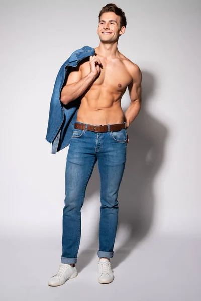 Cheerful Shirtless Man Holding Denim Shirt Standing White — Stock Photo, Image