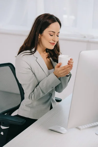 Smiling Secretary Holding Coffee Cup While Sitting Workplace Closed Eyes — Stock Photo, Image