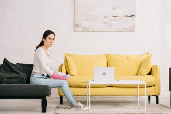 Pensive Housewife Sitting Grey Sofa Table Laptop Looking Camera — Stock Photo, Image