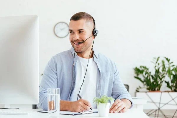 Cheerful Broker Headset Looking Computer Monitor Holding Pen — Stock Photo, Image