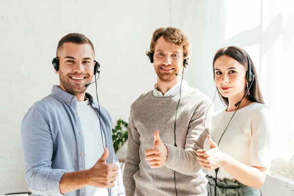 Happy Brokers Headsets Showing Thumbs — Stock Photo, Image