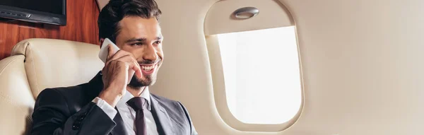 Panoramic Shot Handsome Businessman Suit Smiling Talking Smartphone Private Plane — Stock Photo, Image