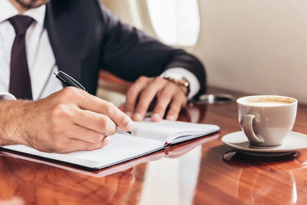 Cropped View Businessman Writing Notebook Private Plane — Stock Photo, Image