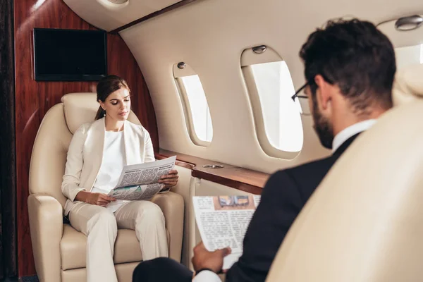 Selective Focus Businessman Businesswoman Reading Newspaper Private Plane — Stock Photo, Image