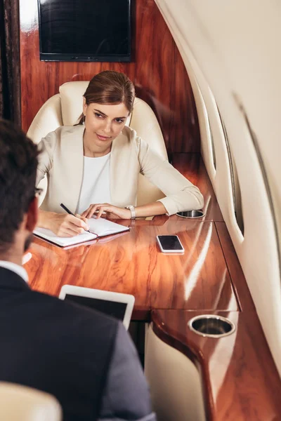 Selective Focus Businesswoman Writing Notebook Private Plane — ストック写真