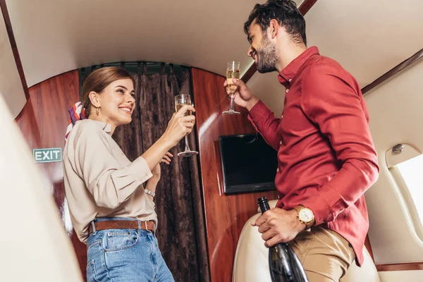 Smiling Boyfriend Bottle Girlfriend Holding Champagne Glasses Private Plane — Stock Photo, Image