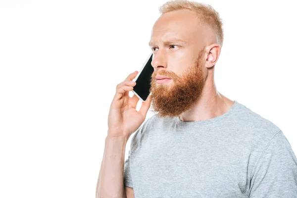 Doordachte Man Met Baard Aan Het Praten Smartphone Geïsoleerd Wit — Stockfoto