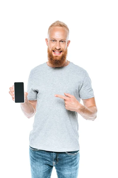 Skäggig Man Pekar Smartphone Med Tom Skärm Isolerad Vit — Stockfoto