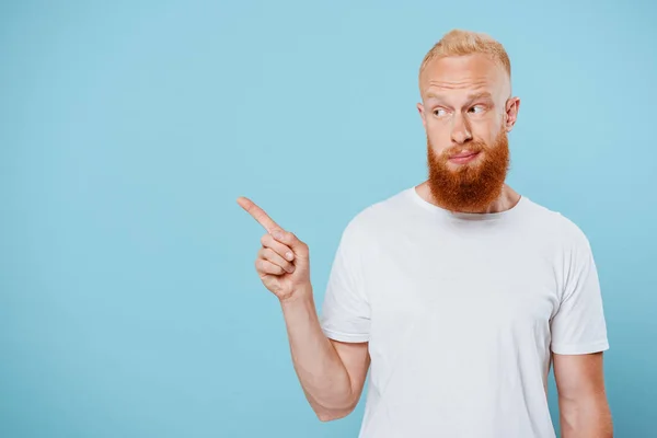 Portrait Sarcastic Bearded Man White Shirt Pointing Something Isolated Blue — Stock Photo, Image