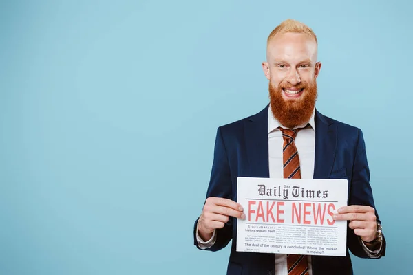 Smiling Bearded Businessman Holding Newspaper Fake News Isolated Blue — Stock Photo, Image