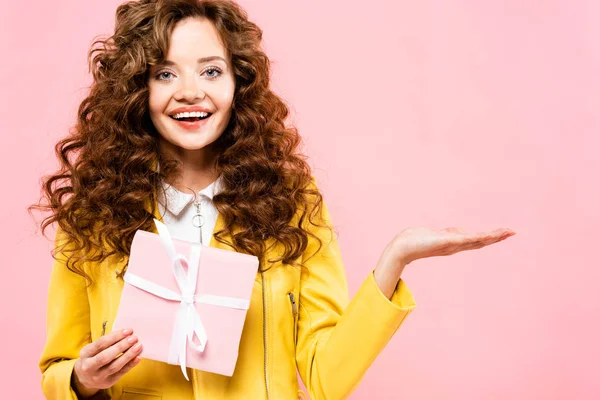 Beautiful Curly Girl Holding Gift Presenting Something Isolated Pink — Stock Photo, Image