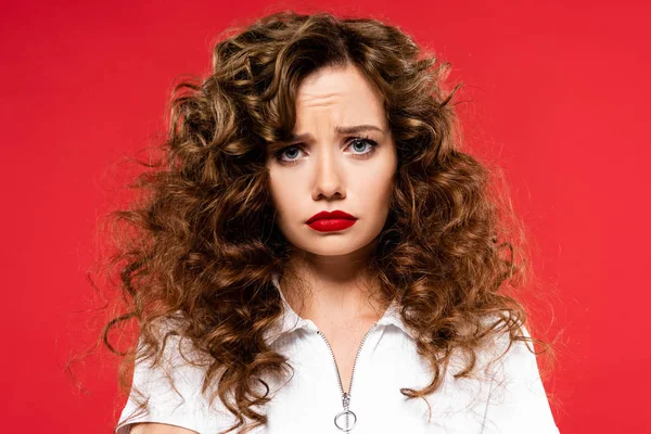 Attractive Upset Curly Girl Looking Camera Isolated Red — Stock Photo, Image