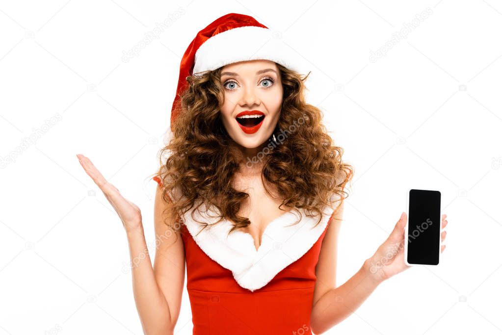excited woman in santa costume showing smartphone, isolated on white