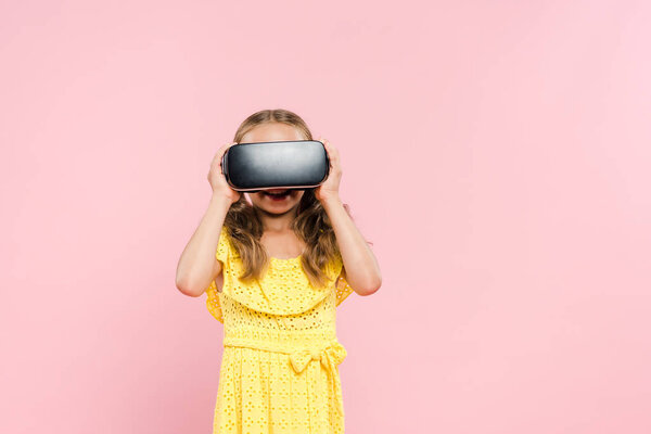 smiling kid with virtual reality headset isolated on pink