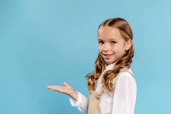 Smiling Cute Kid Outstretched Hand Looking Camera Isolated Blue — Stock Photo, Image