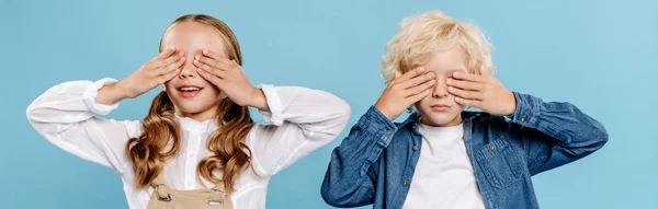 Tiro Panorâmico Crianças Sorridentes Obscurecendo Rostos Isolados Azul — Fotografia de Stock